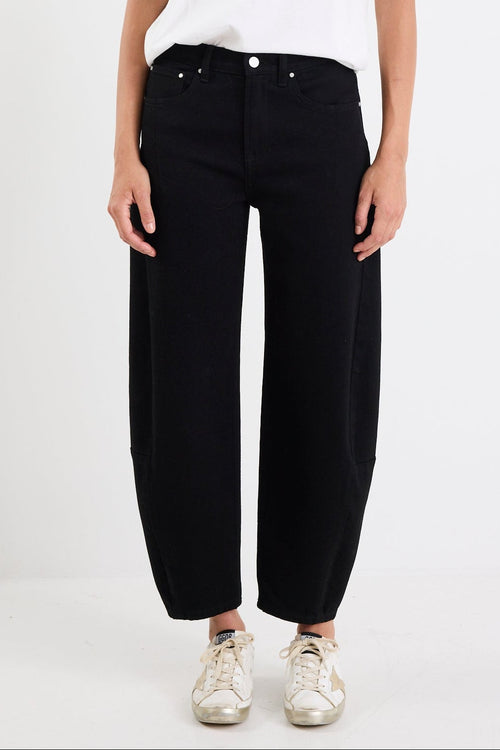 Person wearing a white t-shirt and black pants on a white background