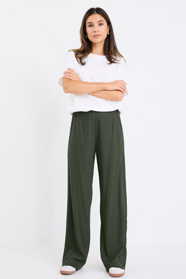 model wears a khaki linen pant with a white t-shirt