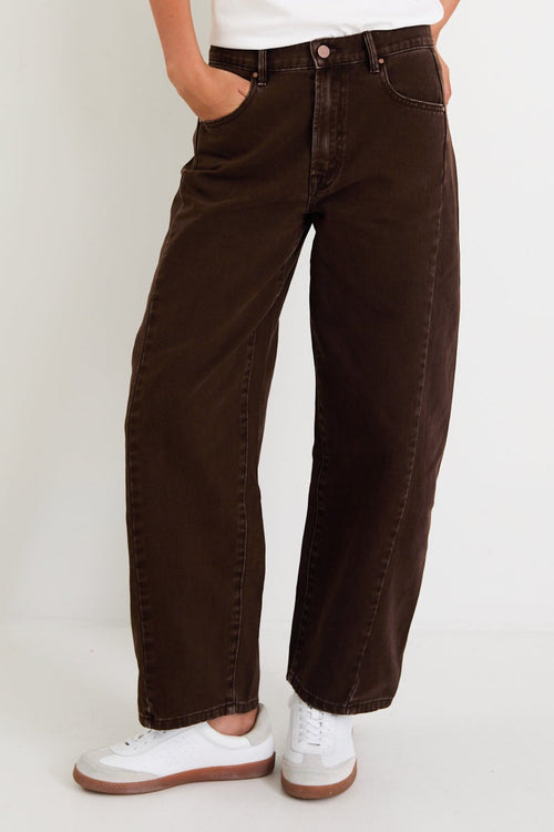 Woman wearing a white t-shirt and brown pants on a white background