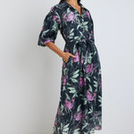 Model wears a black lilac floral maxi tie dress with a collar and button down 