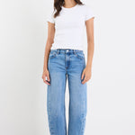 Person wearing a white t-shirt and blue jeans on a white background