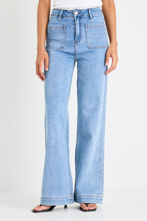 Light blue jeans worn by a person on a white background