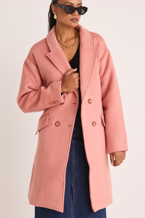 model wears a pink coat