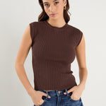 model wears a brown rib knit with blue jeans