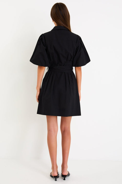 Woman wearing a black dress on a white background