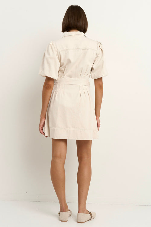 model wears a ecru mini denim dress 