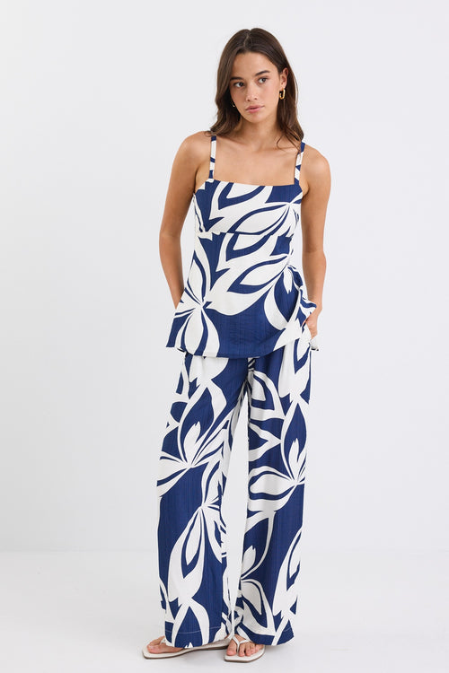 Strapless navy and white floral print cami top with side cut-out details and a flattering silhouette.