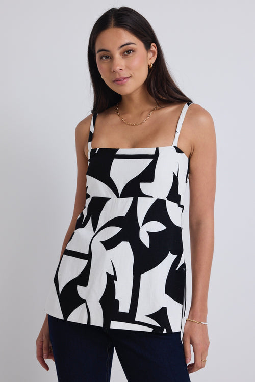 model wears a black and white print top