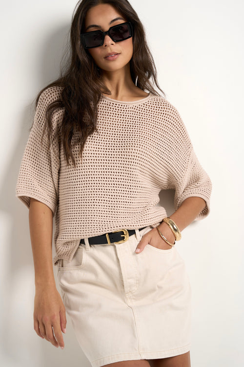 model wears a beige knit t shirt