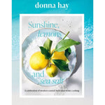 A hardcover book titled "Sunshine, lemons and sea salt" by Donna Hay, featuring a bright turquoise and white cover with a central photo of lemons in sea salt.