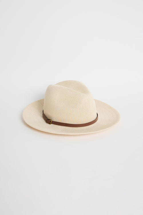 Taupe woven Panama-style hat with a brown band and gold buckle detail, photographed on a white background