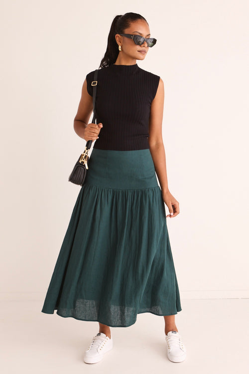 model wears a green linen midi skirt