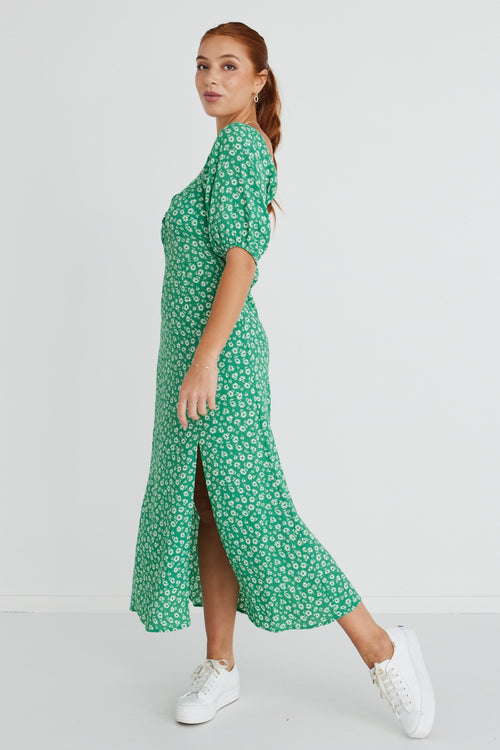 Model wears a green floral print maxi dress.