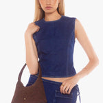 Chocolate brown faux suede shoulder bag with a single strap, crescent silhouette, and gold zip closure, displayed front-facing on a white background.