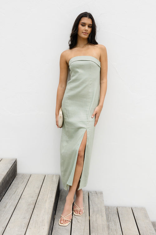 model posing outside in green maxi strapless dress