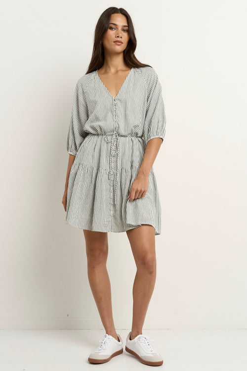 model wears a green and white stripe mini dress