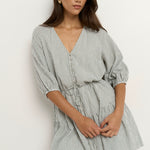 model wears a green and white stripe mini dress