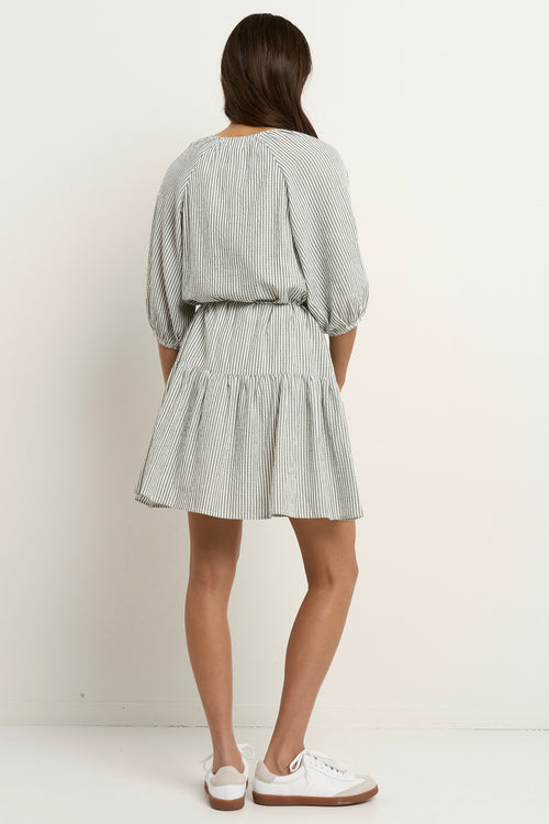 model wears a green and white stripe mini dress