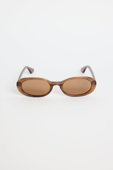 Sunglasses with brown lenses and thin metal frames on a white background