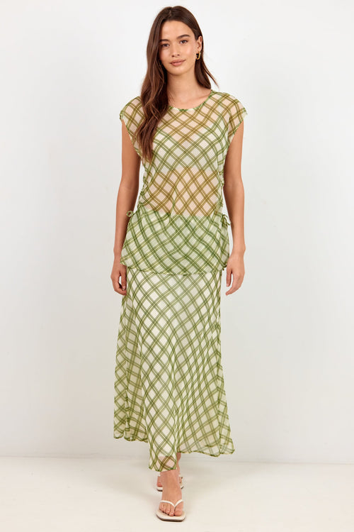 A woman modeling a two-piece matching set featuring a short-sleeve crop top and a maxi skirt, both in a green and beige gingham checkered pattern, set against a plain white studio background.