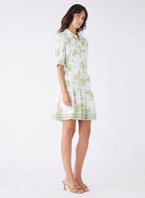 Woman wearing a light-colored dress with floral patterns on a white background