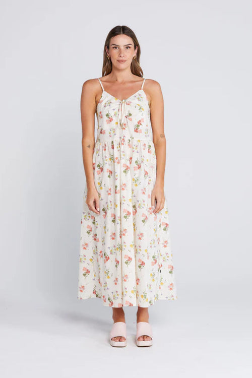 Woman wearing a floral cream long dress