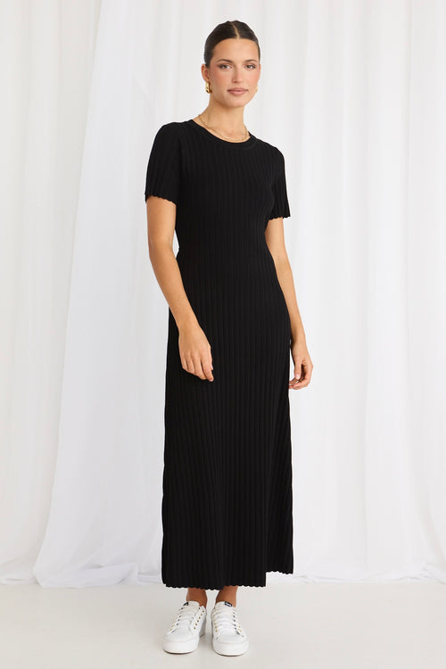 model wears a black knit midi dress