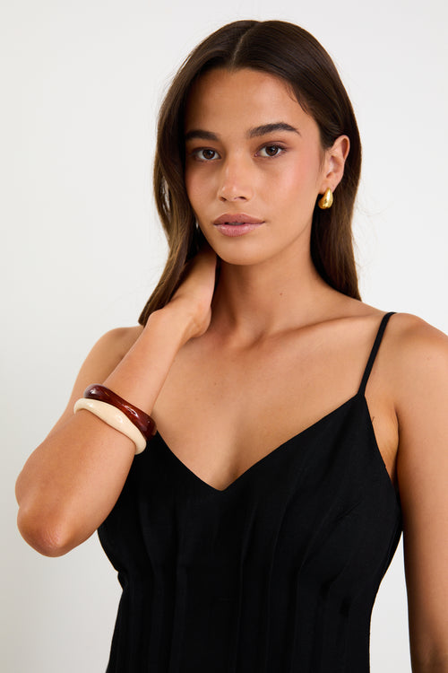 Woman wearing a black dress with a plain background