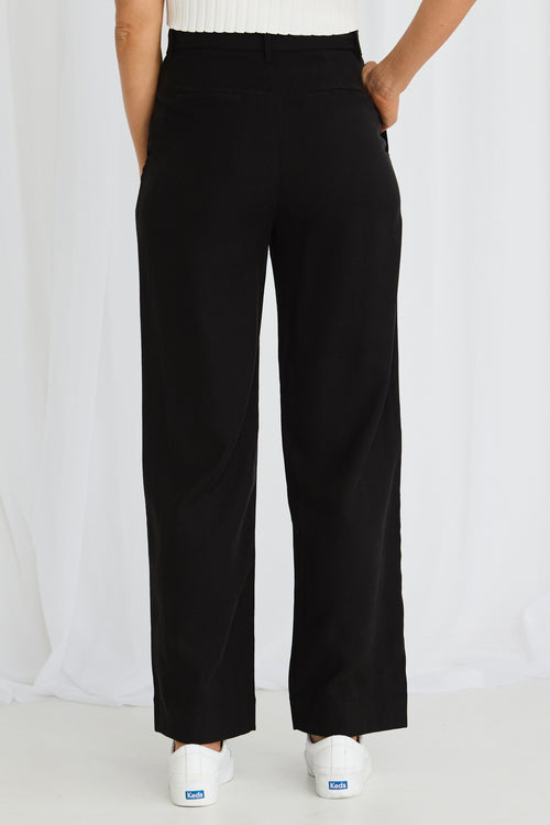 model wears black pleated pants