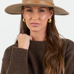Woman wearing taupe beige wool hat.