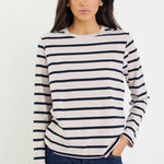 Woman wearing a striped sweater and jeans on a white background