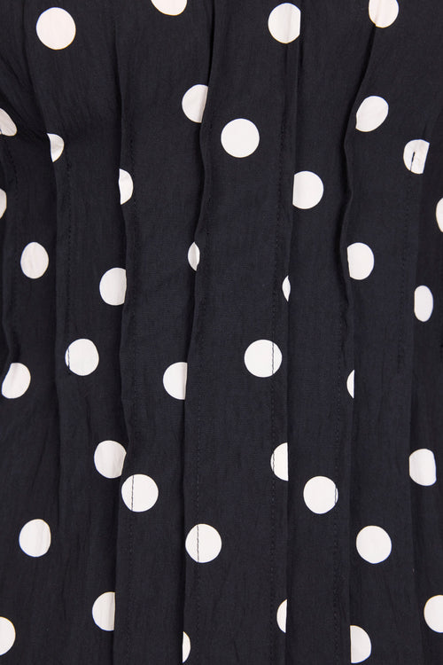 Close-up of black fabric with white polka dots