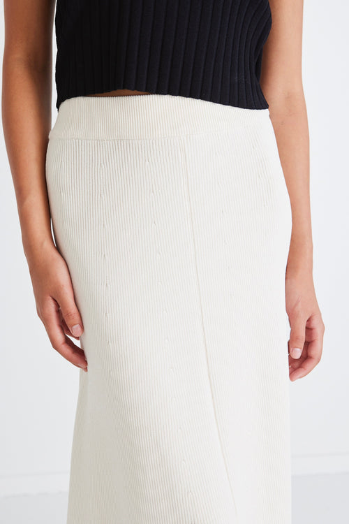 model wears a beige knit maxi skirt