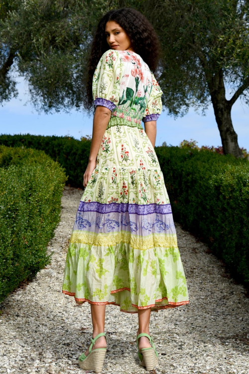 model wears green floral midi dress