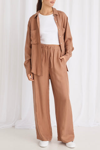 model wears brown pants