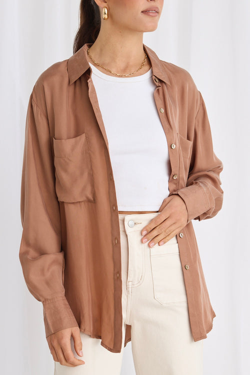 model wears a brown shirt