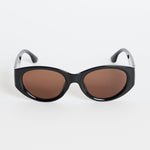 Black sunglasses with brown lenses on a white background