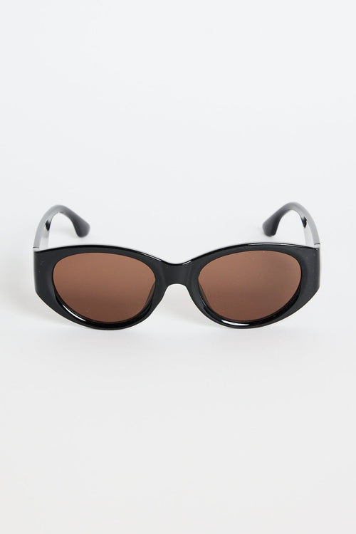 Black sunglasses with brown lenses on a white background