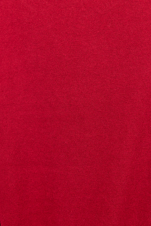 A close-up of a solid red knit fabric texture, filling the entire frame.