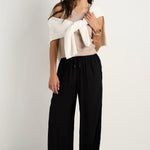 model wears black wide leg pants