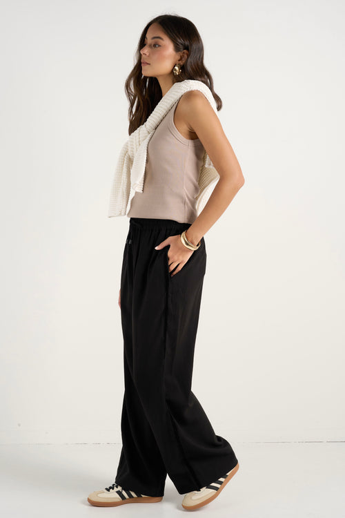 model wears black wide leg pants