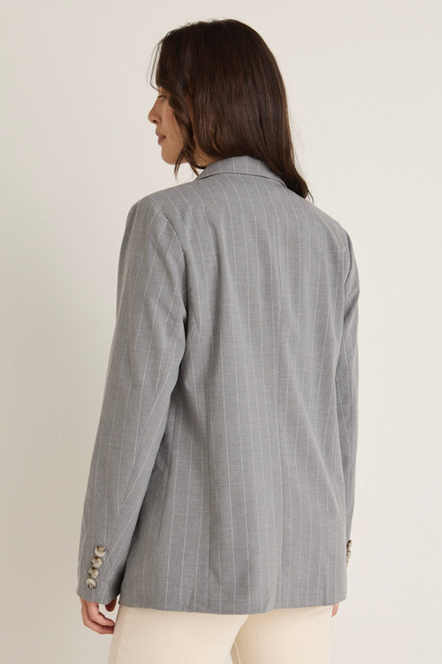 model wears a grey blazer