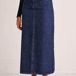 model wears a blue denim maxi skirt