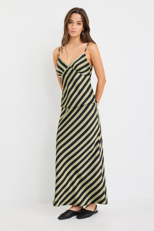 model wearing a silky green black stripe skirt