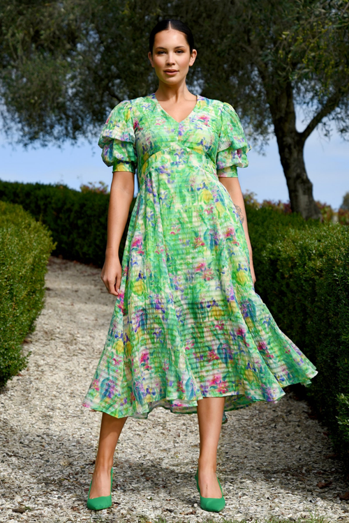 model wears green floral midi dress