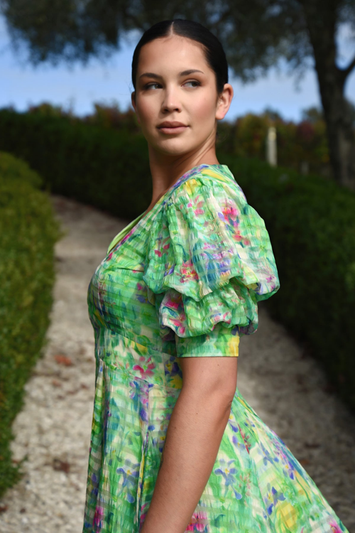 model wears green floral midi dress