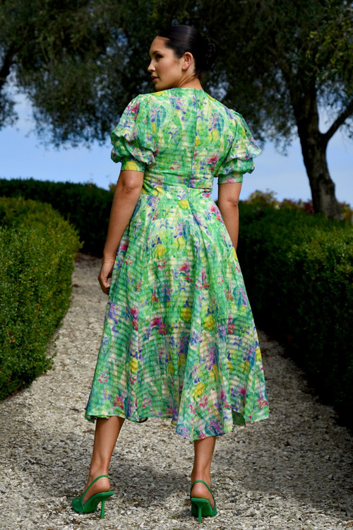 model wears green floral midi dress