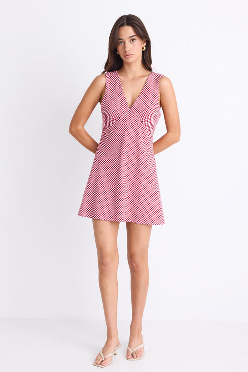 A sleeveless red and white gingham mini dress with a flattering V-neckline. Fully lined for comfort, made from 100% Cotton for a breathable, natural feel.