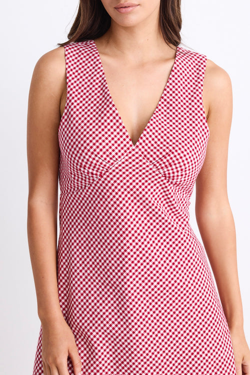 A sleeveless red and white gingham mini dress with a flattering V-neckline. Fully lined for comfort, made from 100% Cotton for a breathable, natural feel.