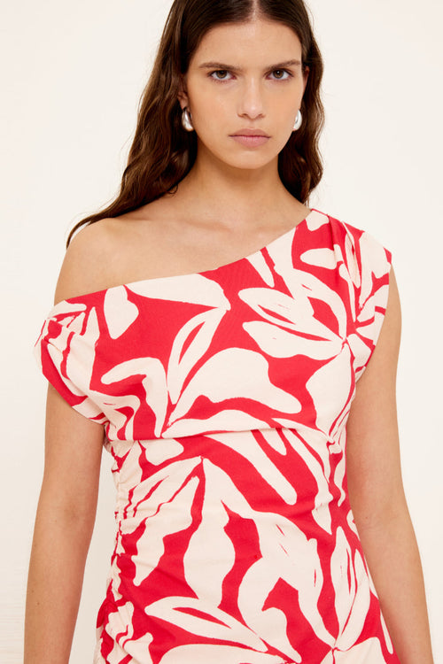 Woman wears a red white floral asymmetric dress